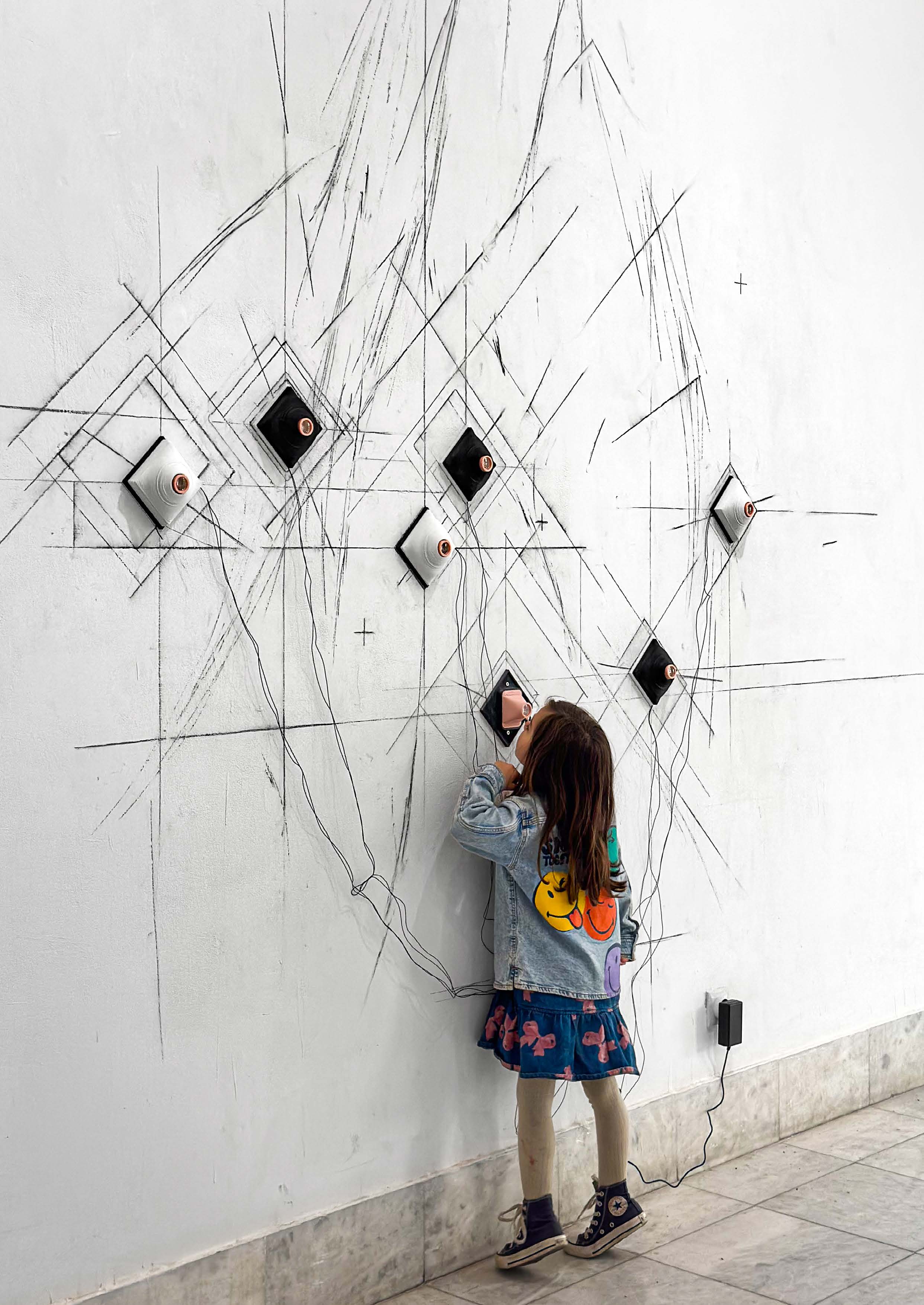 Proleće/leto 2028K, 2025, installation view with a child looking through a lens