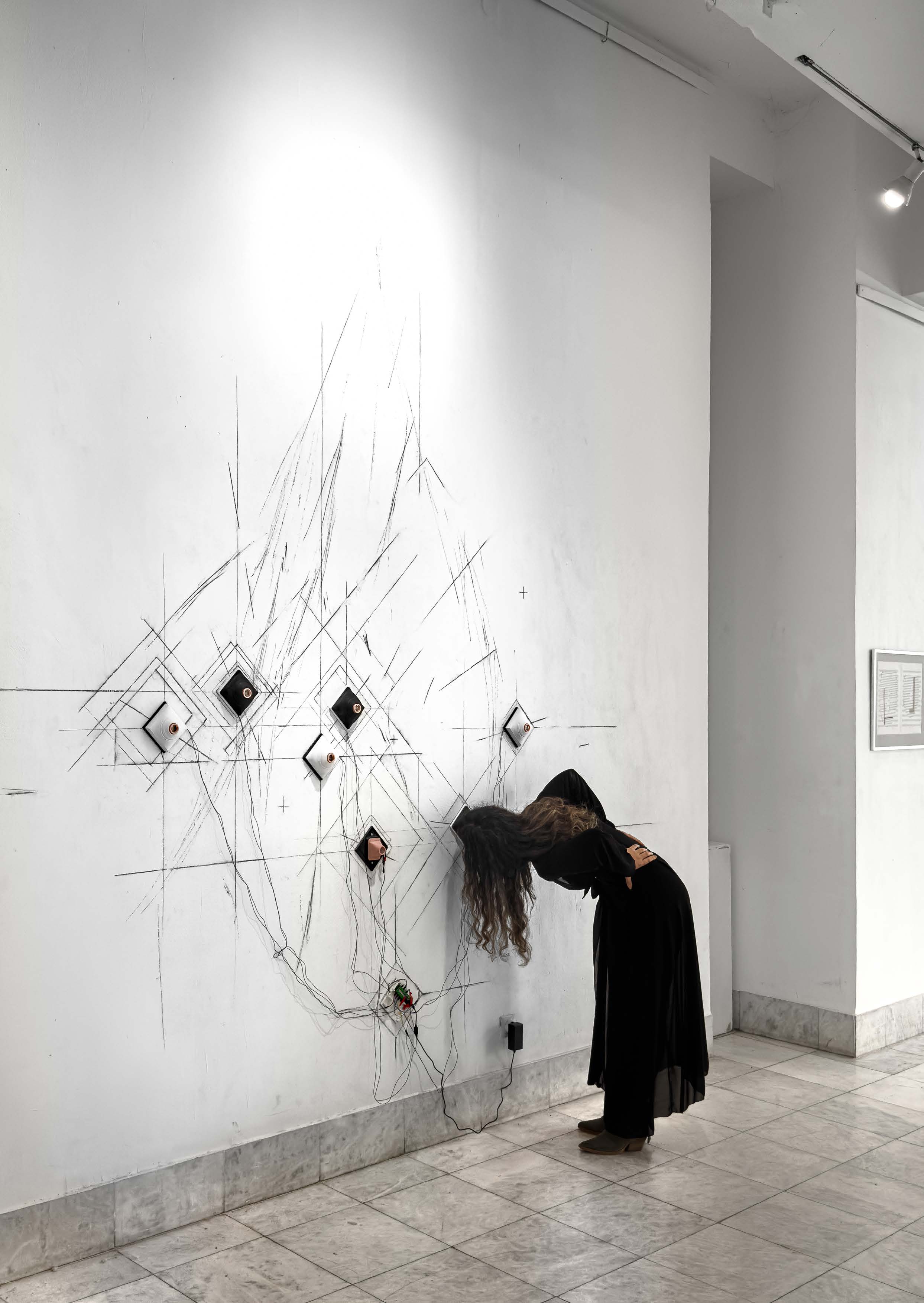 Proleće/leto 2028K, 2025, installation view with a visitor looking through a lens